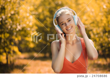 Young woman with headphones listening to music in 24708686