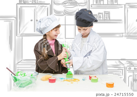 Children making christmas cupcakes Children making christmas cupcakes 24715550