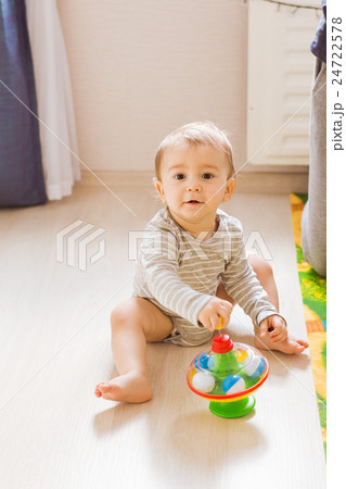 Baby boy plays in his room. 24722578