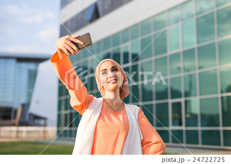 muslim woman taking selfie 24722725