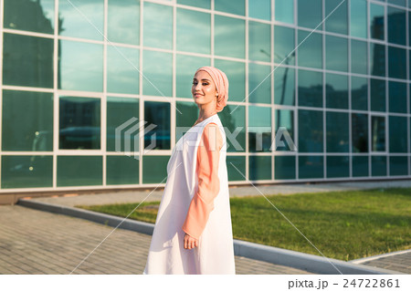 Young woman wearing hijab head scarf in city. 24722861