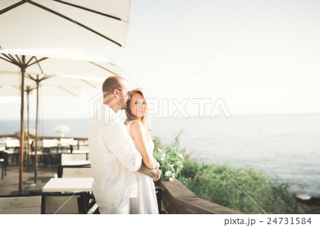 Just married wedding couple walking on the beach 24731584