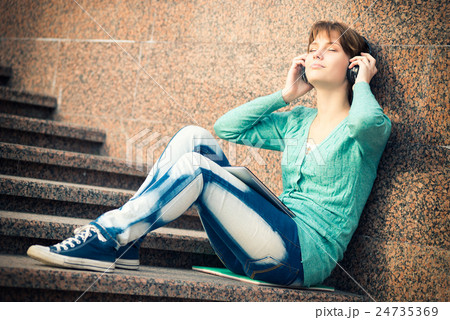 Beautiful young woman student with headphones Beautiful young woman student with headphones 24735369