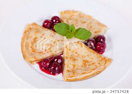 pancakes with cherry sauce and mint  24737428