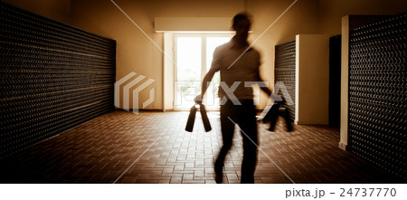 Winemaker in cellar holding in these hands red 24737770