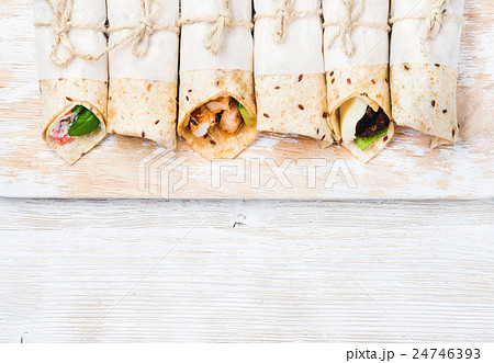 Tortilla wraps with various fillings on shabby 24746393