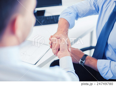 businessmen shaking hands in office 24749780