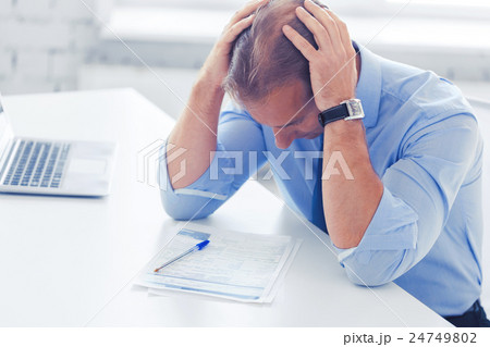 stressed businessman with papers at work stressed businessman with papers at work 24749802