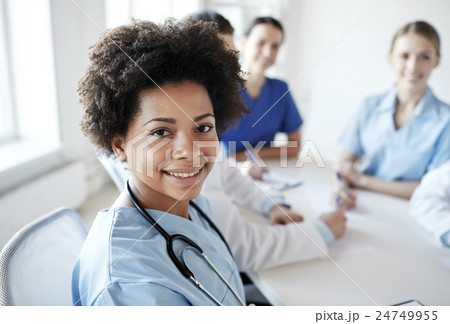 happy doctor over group of medics at hospital 24749955