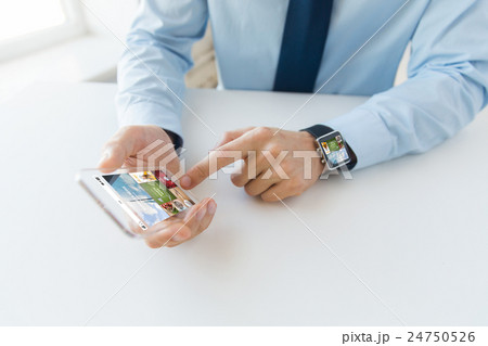 close up of hands with smart phone and watch 24750526