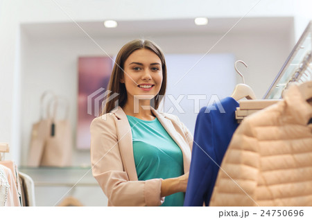 happy young woman choosing clothes in mall happy young woman choosing clothes in mall 24750696