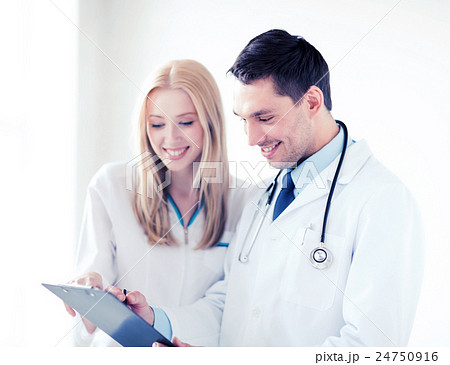 two doctors writing prescription two doctors writing prescription 24750916