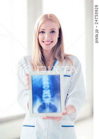 female doctor with x-ray on tablet pc female doctor with x-ray on tablet pc 24750926