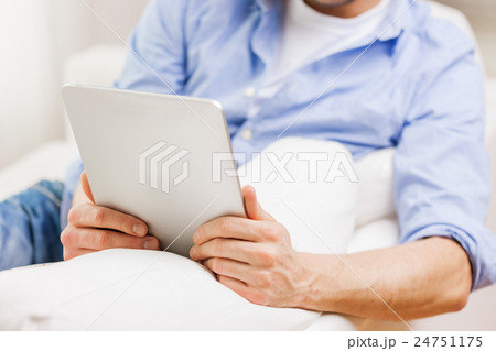 close up of man working with tablet pc at home close up of man working with tablet pc at home 24751175