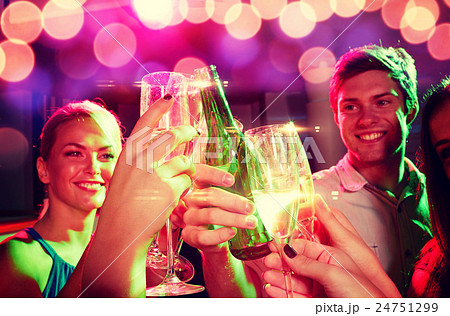 smiling friends with wine glasses and beer in club 24751299
