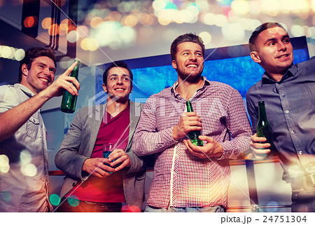 group of male friends with beer in nightclub 24751304