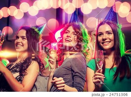 smiling friends with glasses of champagne in club smiling friends with glasses of champagne in club 24751306