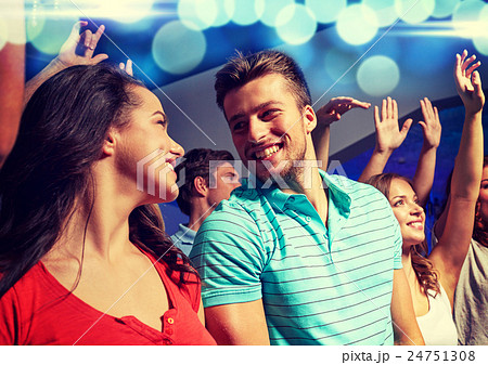 smiling friends at concert in club 24751308