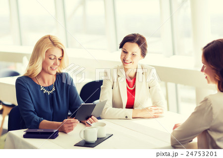 happy women looking at restaurant bill 24753201