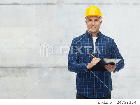 smiling male builder in helmet with clipboard 24753324
