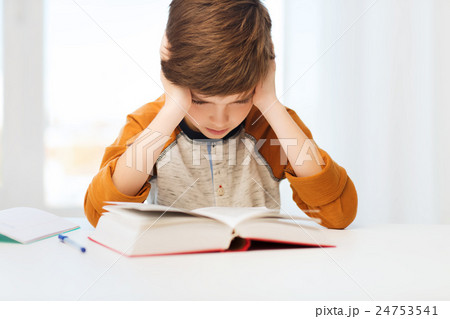 student boy reading book or textbook at home 24753541