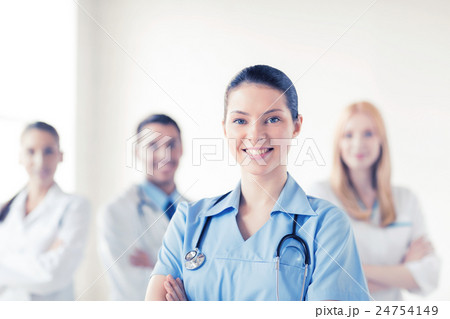 female doctor in front of medical group female doctor in front of medical group 24754149
