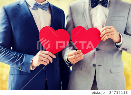 close up of male gay couple holding red hearts close up of male gay couple holding red hearts 24755118