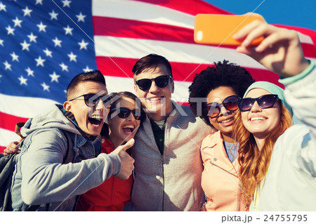 smiling friends taking selfie with smartphone 24755795
