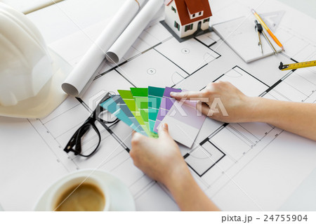 close up of hands with color palette and blueprint 24755904