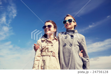 happy little girls in sunglasses hugging outdoors happy little girls in sunglasses hugging outdoors 24756128