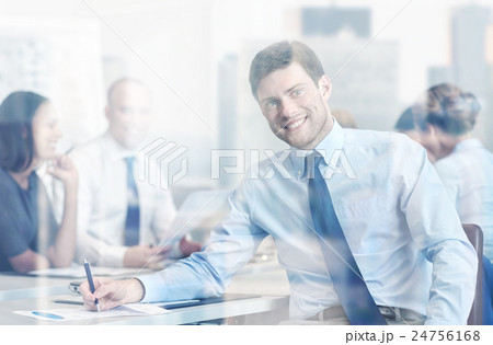 group of smiling businesspeople meeting in office group of smiling businesspeople meeting in office 24756168