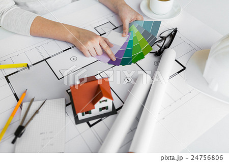 close up of hands with color palette and blueprint 24756806