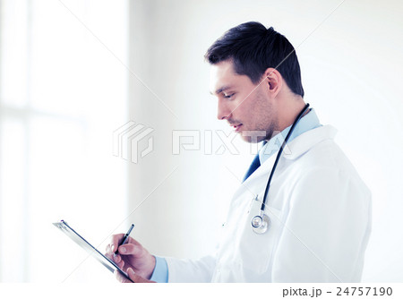 male doctor with stethoscope writing prescription male doctor with stethoscope writing prescription 24757190