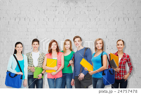 group of teenage students with folders and bags group of teenage students with folders and bags 24757478