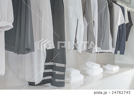 black and white color tone clothes hanging on rail 24762745