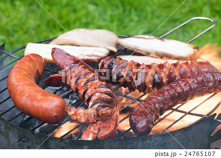 Sausages and bacon on the grill Sausages and bacon on the grill 24765107