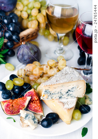 Wine, grape and cheese over white Wine, grape and cheese over white 24765444