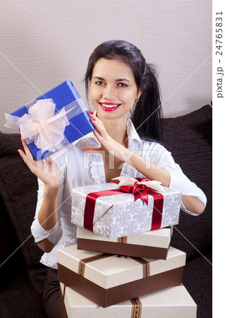 woman smiling and holds gift box woman smiling and holds gift box 24765831
