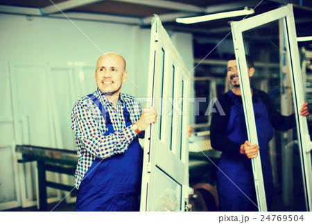 Workmen inspecting PVC manufacturing output Workmen inspecting PVC manufacturing output 24769504