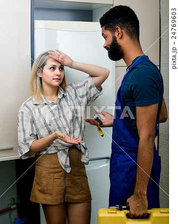 housewife and handyman near fridge housewife and handyman near fridge 24769603