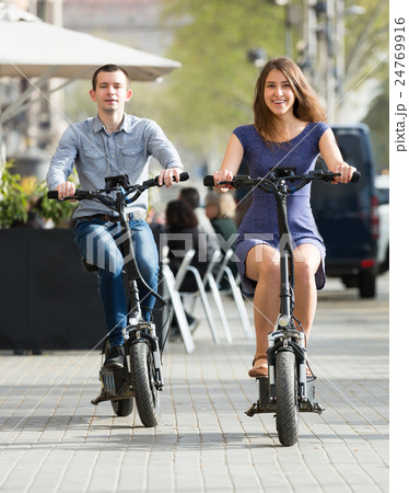Young couple with electric bikes . 24769916