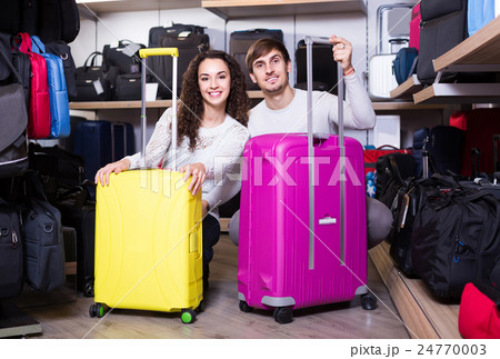 customers looking at roll-aboard bags in store 24770003
