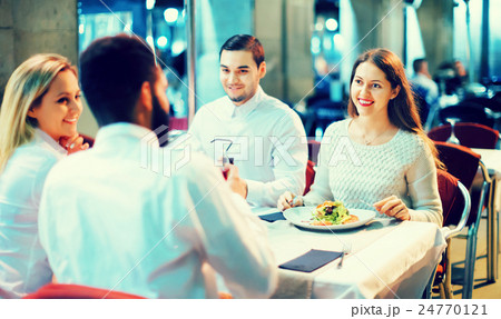 Portrait of relaxed and happy smiling adults having dinner Portrait of relaxed and happy smiling adults having dinner 24770121