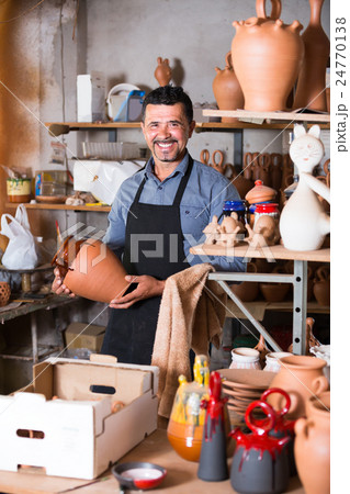 Male artisan in ceramic workshop. 24770138