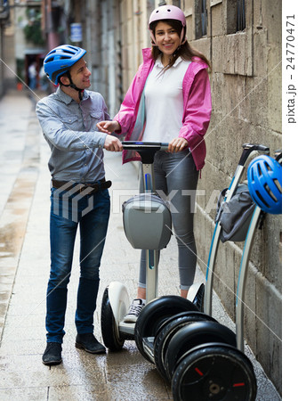 Boy and girl parking their segways Boy and girl parking their segways 24770471