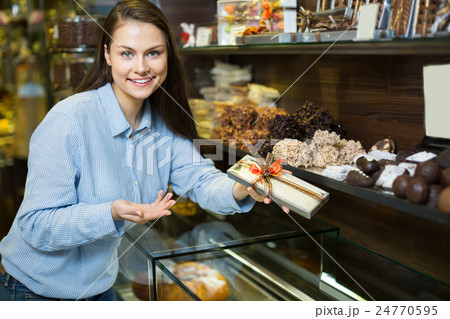 Girl buying chocolate 24770595