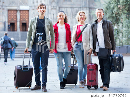Happy family of four with trunks and bags Happy family of four with trunks and bags 24770742