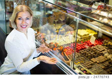 Senior customer choosing chocolates. Senior customer choosing chocolates. 24770743