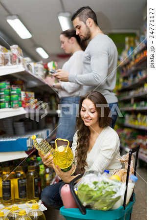 Customers choosing seed-oil at shop Customers choosing seed-oil at shop 24771177