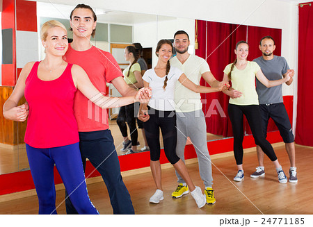 Group of people dancing salsa in studio 24771185